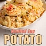 Pinterest graphic of Deviled Egg Potato Salad on a white platter topped with deviled egg halves, pickled red onions, capers and paprika, with title text reading Deviled Egg Potato Salad and The Salted Pepper logo.