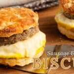 The Salted Pepper branded photo of a Breakfast Sausage and Egg Biscuit sandwich on a wood board with a spatula and the Sausage and Egg Biscuit title overlay.